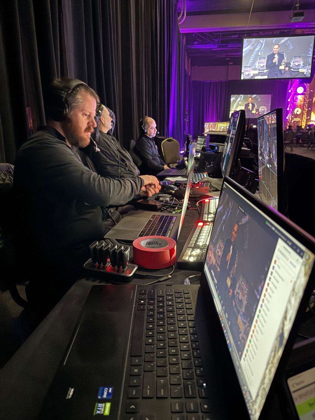 SwissMixx Audio video production team monitoring live feed at corporate awards ceremony with multiple screens