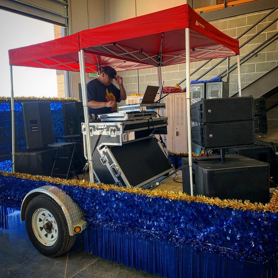 SwissMixx Audio DJ rig and RCF line array speakers mounted on a decorated parade trailer for the COVID city parade