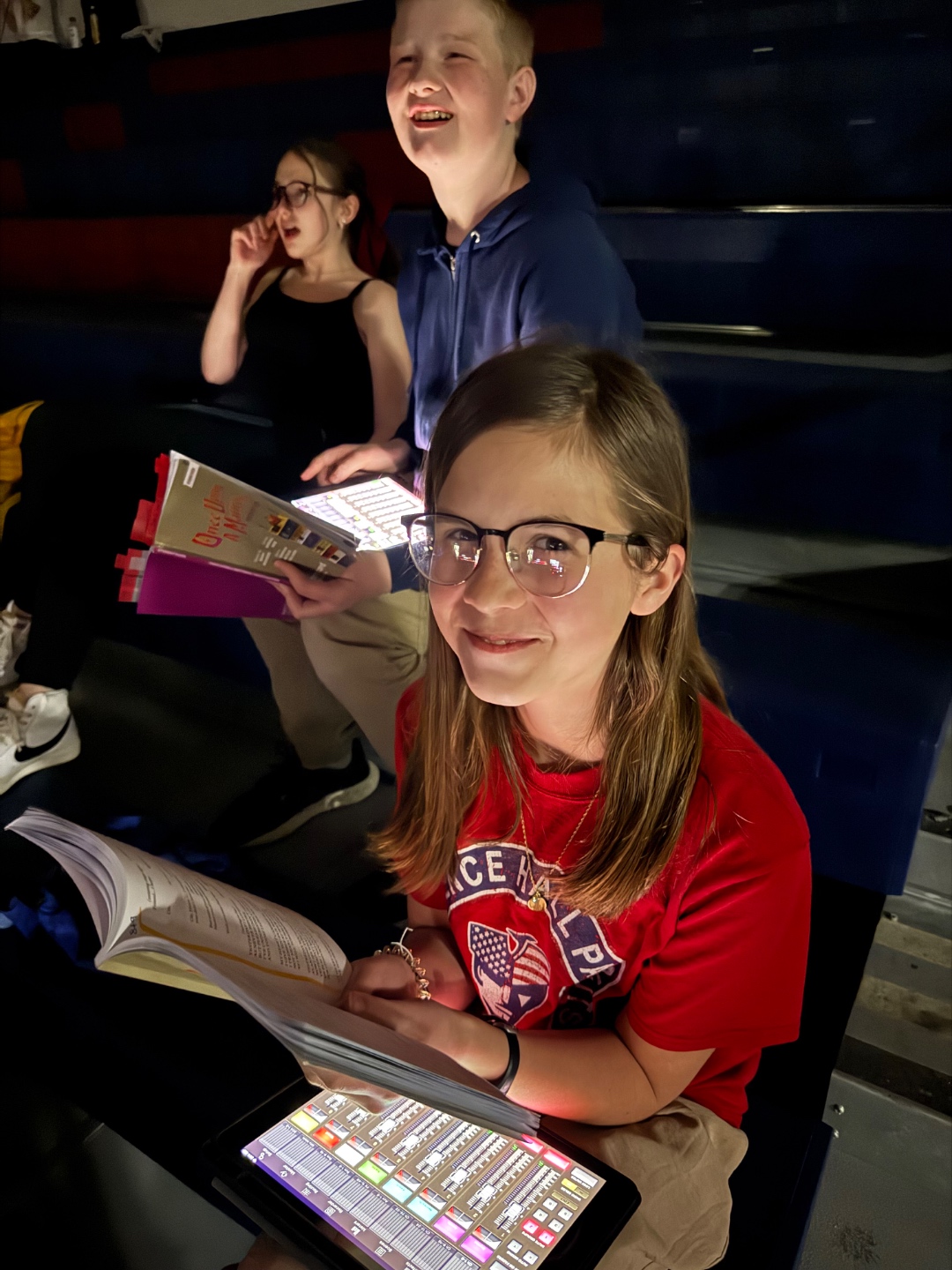 Student running iPad XAir app with script during school show, hands-on audio training Boise Idaho