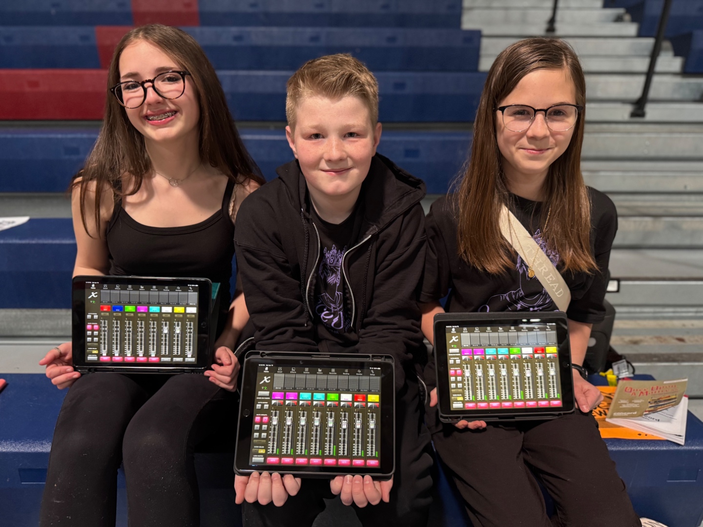 Three students using iPad X-Air app to mix sound during school production, SwissMixx Audio education Boise Idaho
