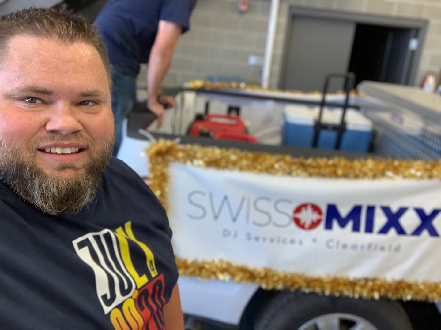Mark Christiansen with the SwissMixx Audio branded parade float used to DJ 45 miles through the city during COVID