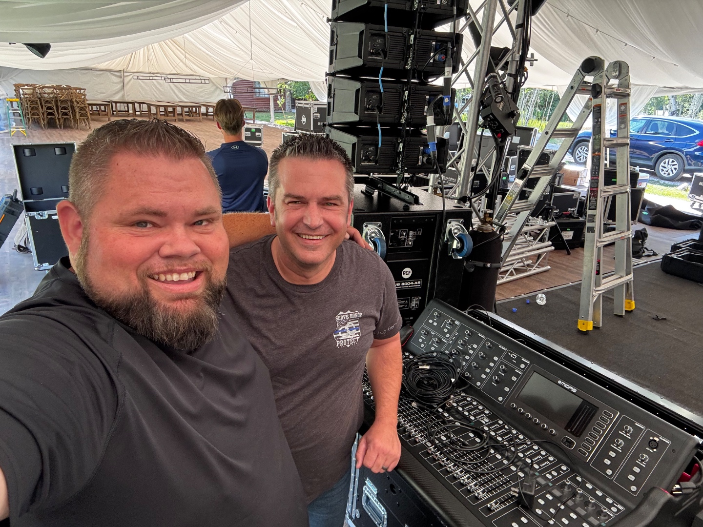 Mark Christiansen and crew setting up RCF line array system inside a tent venue with Midas digital console, SwissMixx Audio live event production