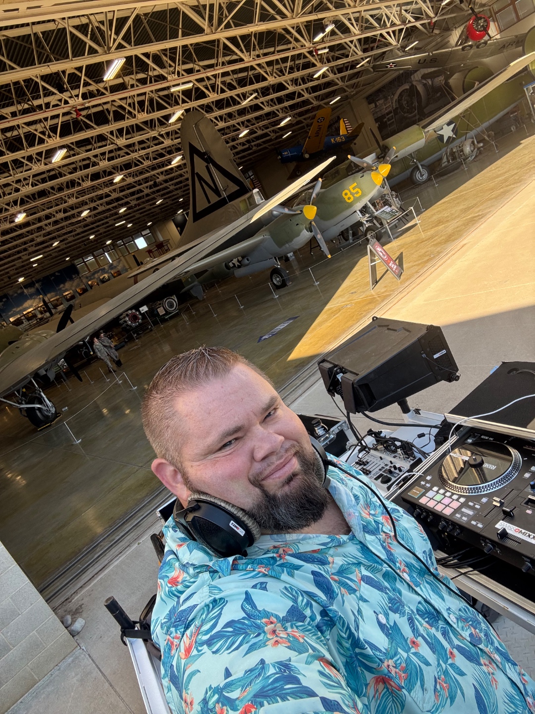 Mark Christiansen DJing inside the Hill Air Force Base Museum with vintage WWII aircraft visible in the background, SwissMixx Audio corporate AV Utah