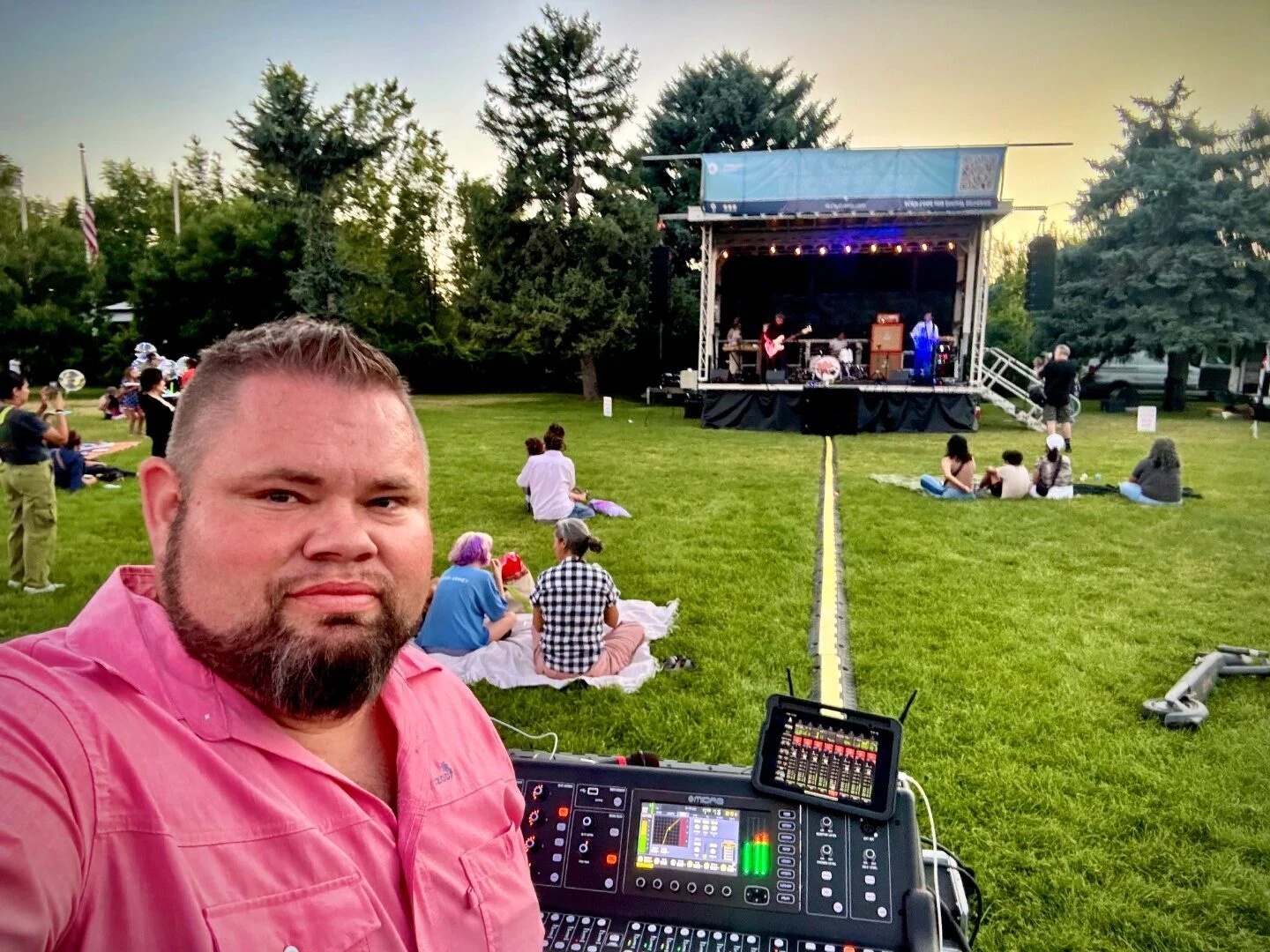 SwissMixx Audio running front of house at a city park festival stage