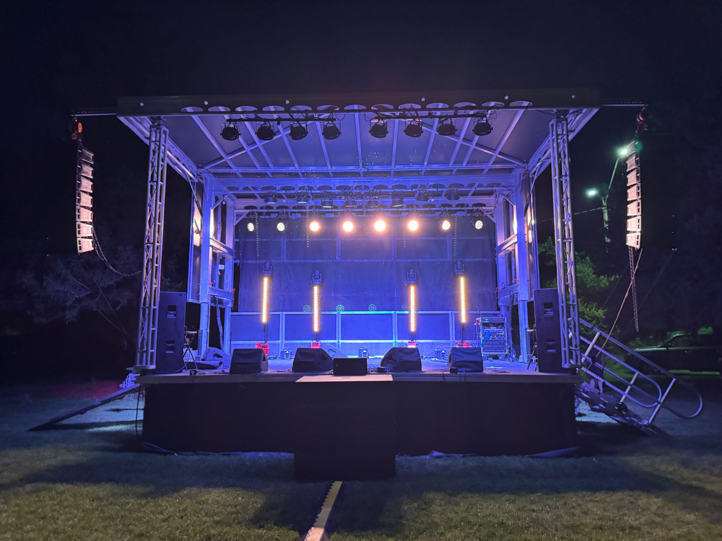 Professional outdoor stage at night with full line array sound system and lighting rig, SwissMixx Audio