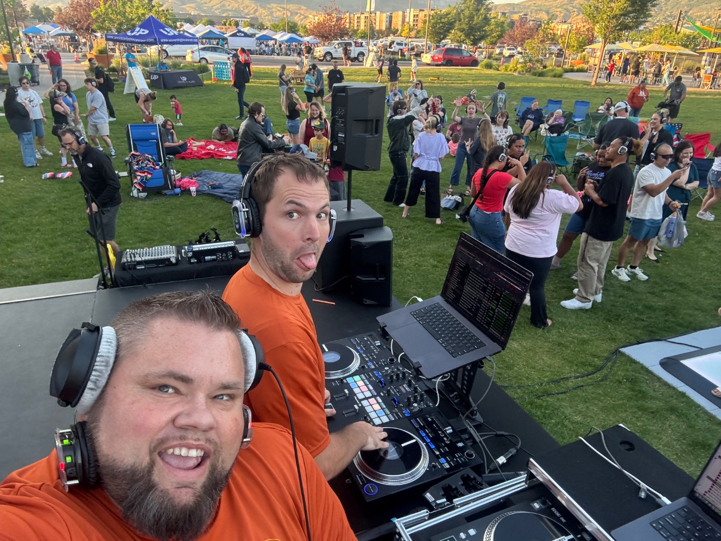 Mark Christiansen and team DJing an outdoor park silent disco with a huge crowd wearing LED wireless headsets dancing behind him, SwissMixx Audio Treasure Valley Idaho
