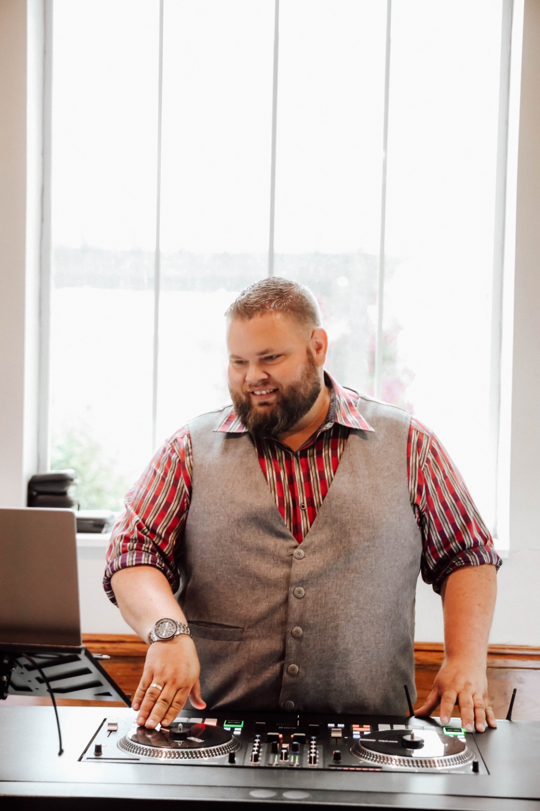 Mark Christiansen smiling at the DJ booth during a wedding reception, SwissMixx Audio professional wedding DJ Treasure Valley