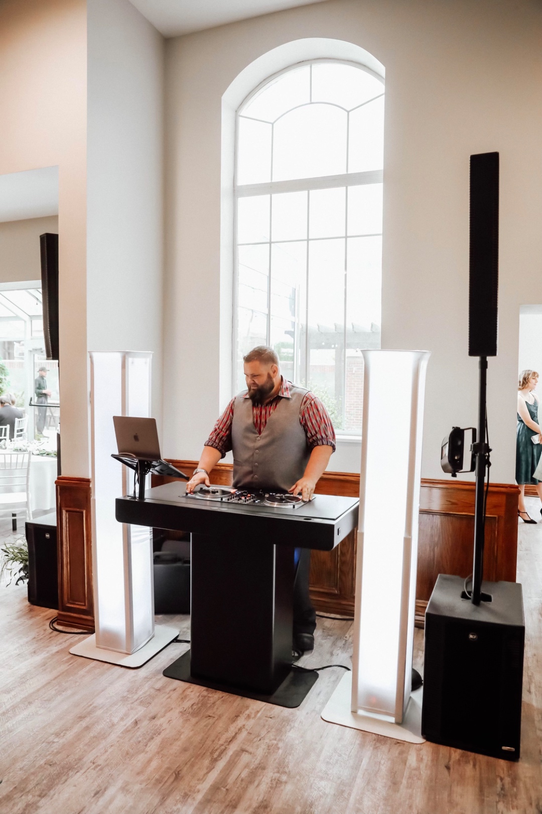 Mark Christiansen DJing at an elegant wedding reception with white lighting columns and RCF subwoofer, professional wedding DJ Boise Idaho