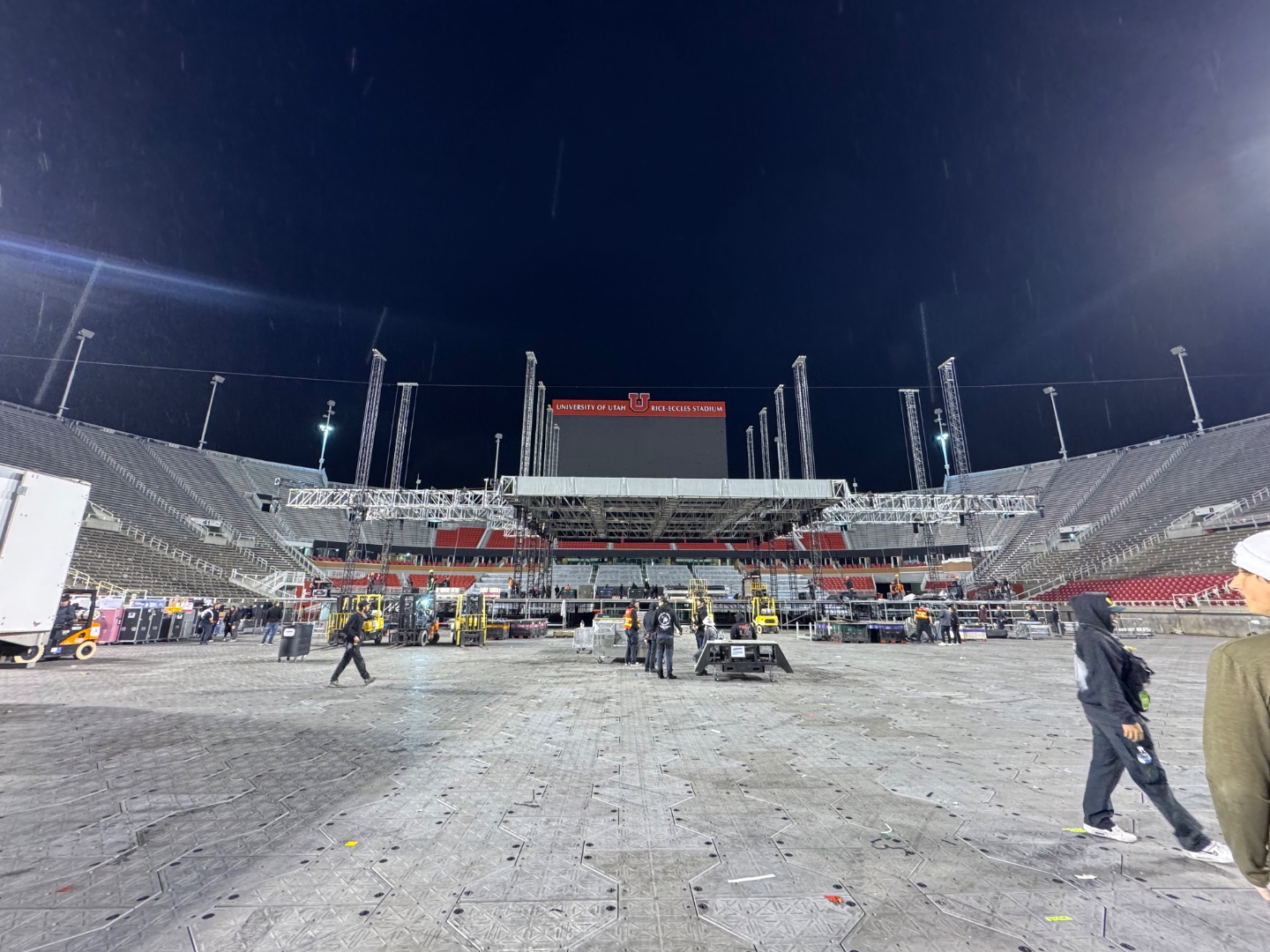 Wide angle view of Rice-Eccles Stadium floor during the Post Malone and Jelly Roll production load-in with full stage rig being assembled