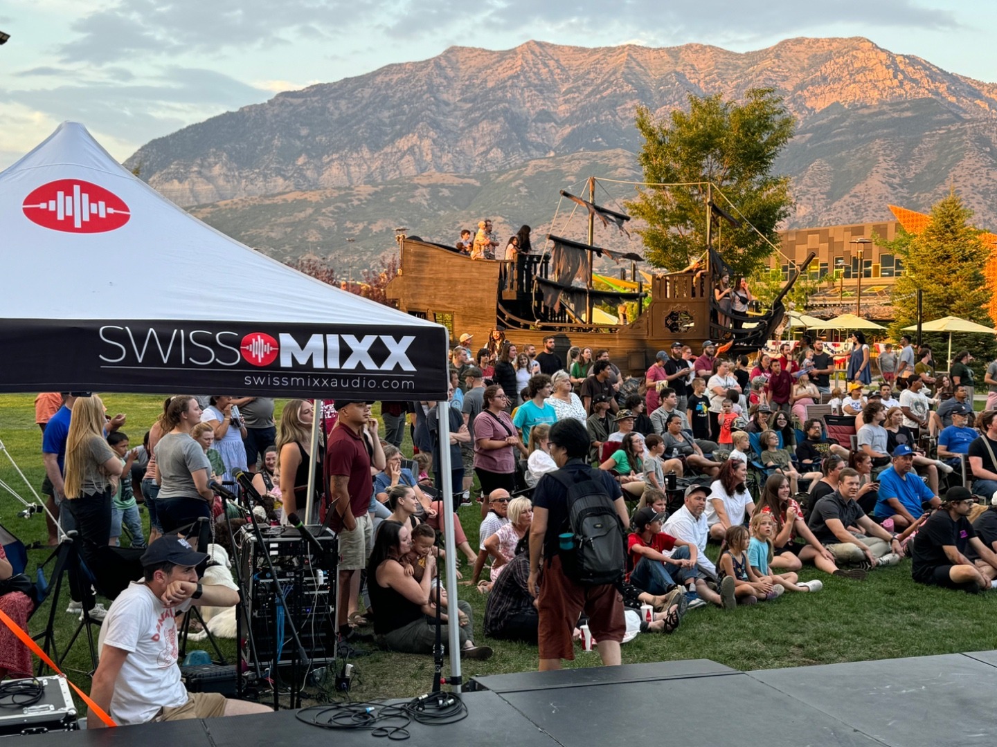 SwissMixx Audio live event with crowd, mountains, and lake backdrop