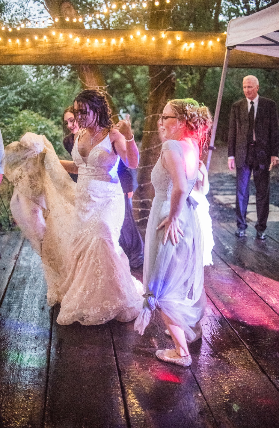 Bride dancing under outdoor string lights at wedding reception in Treasure Valley Idaho