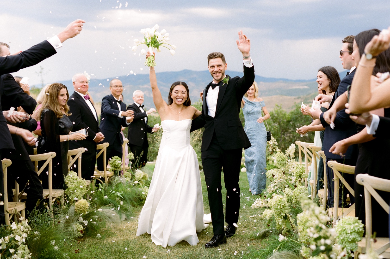 Bride and groom recessional walk at outdoor Idaho wedding ceremony with mountain backdrop, SwissMixx Audio